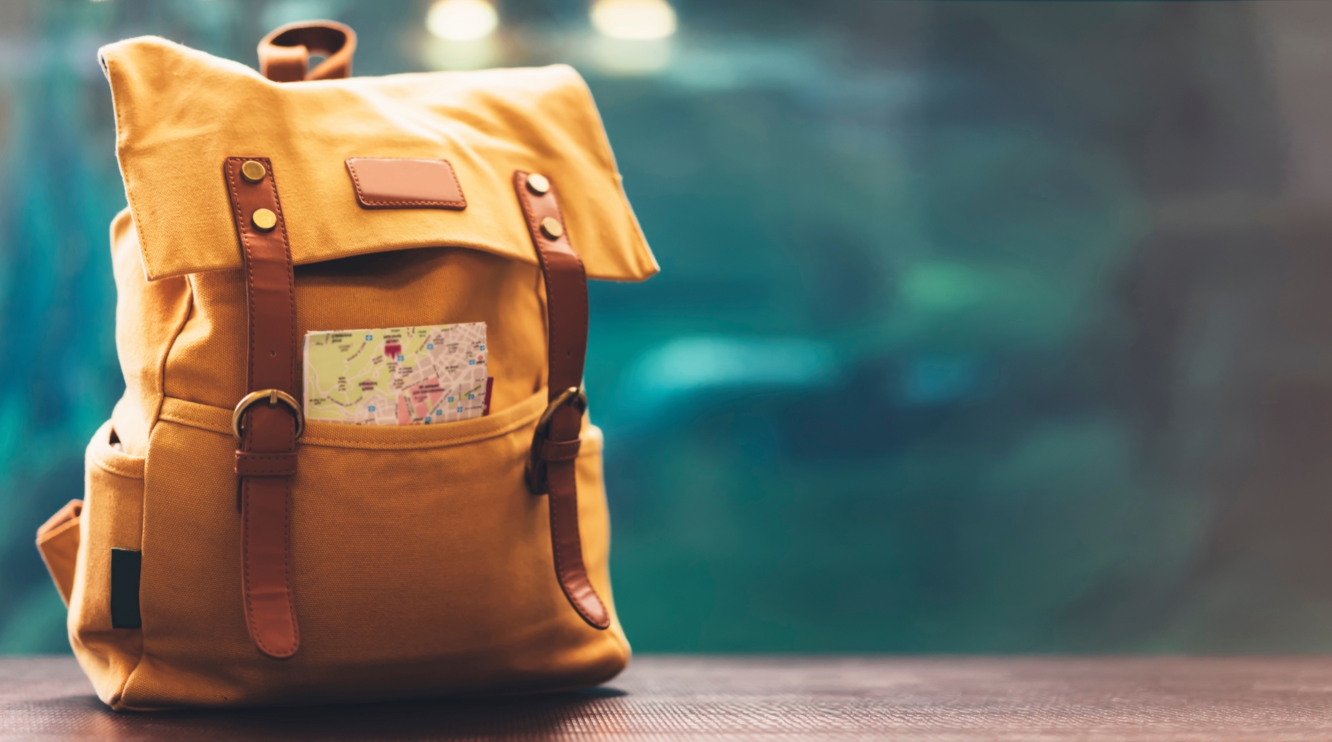 Yellow backpack with a map tucked in the pocket